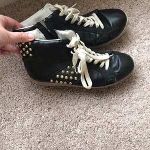 Gold studded and black tennis shoes